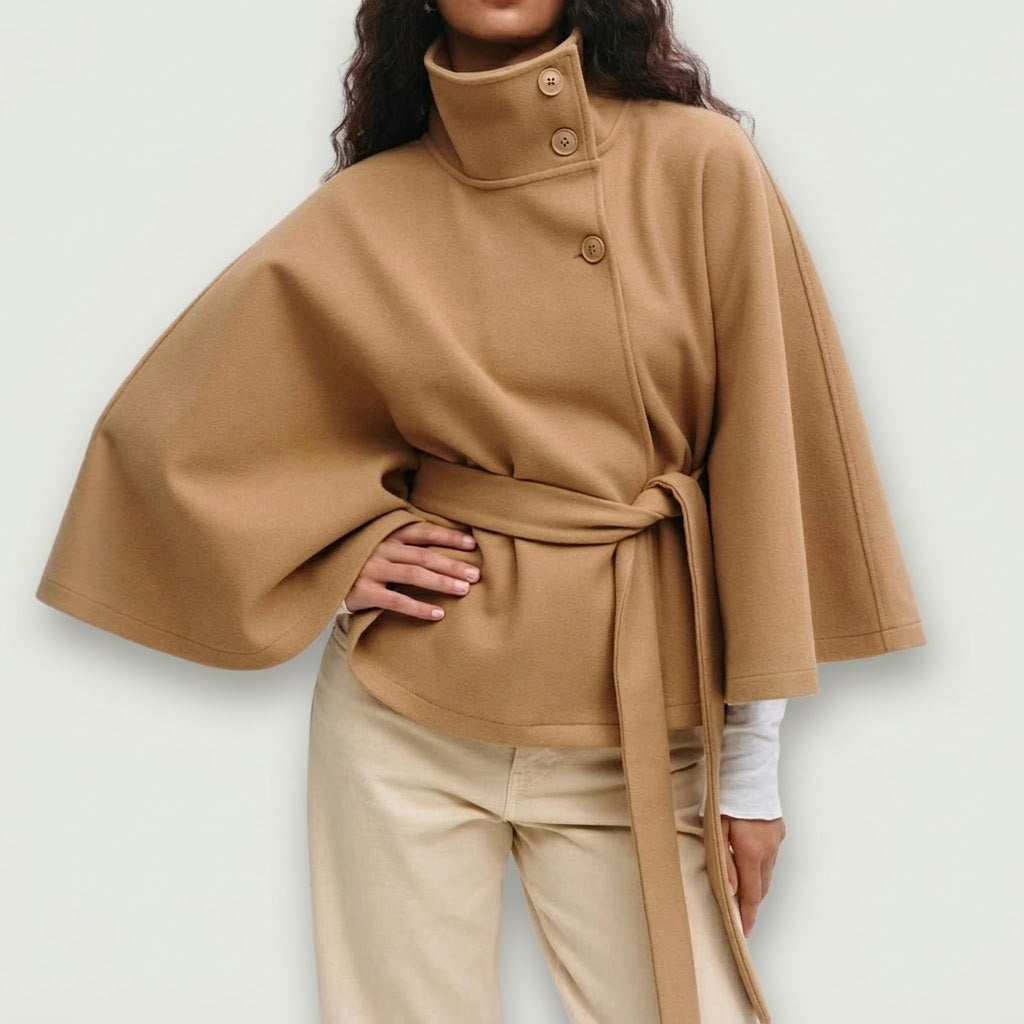 Woman wearing Snuvelle high neck batwing belted coat in a solid color