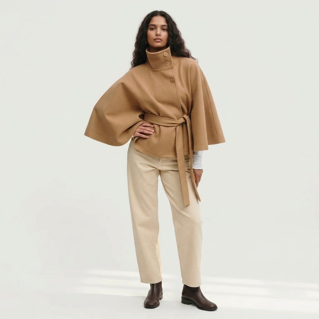 Woman wearing Snuvelle high neck batwing belted coat in a solid color