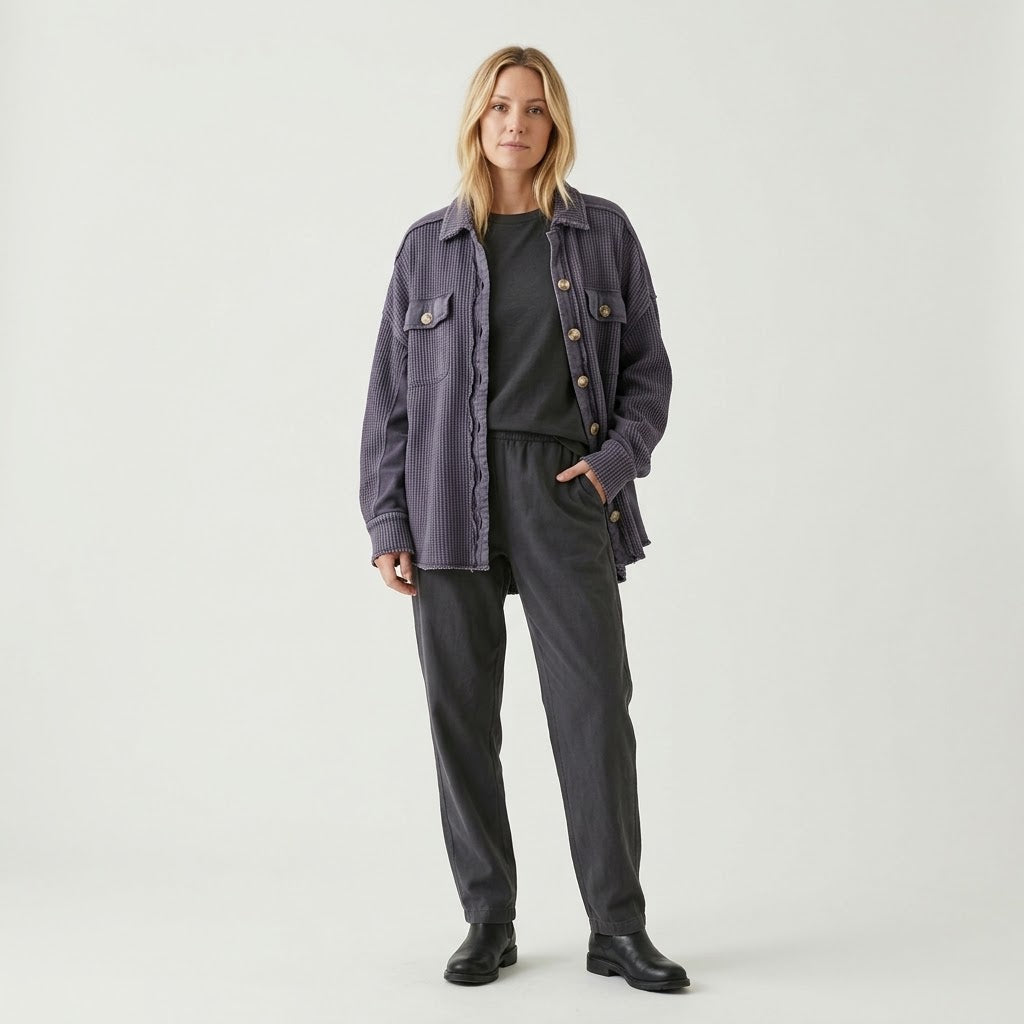 Woman wearing Snuvelle button-up lapel shirt jacket in a solid color