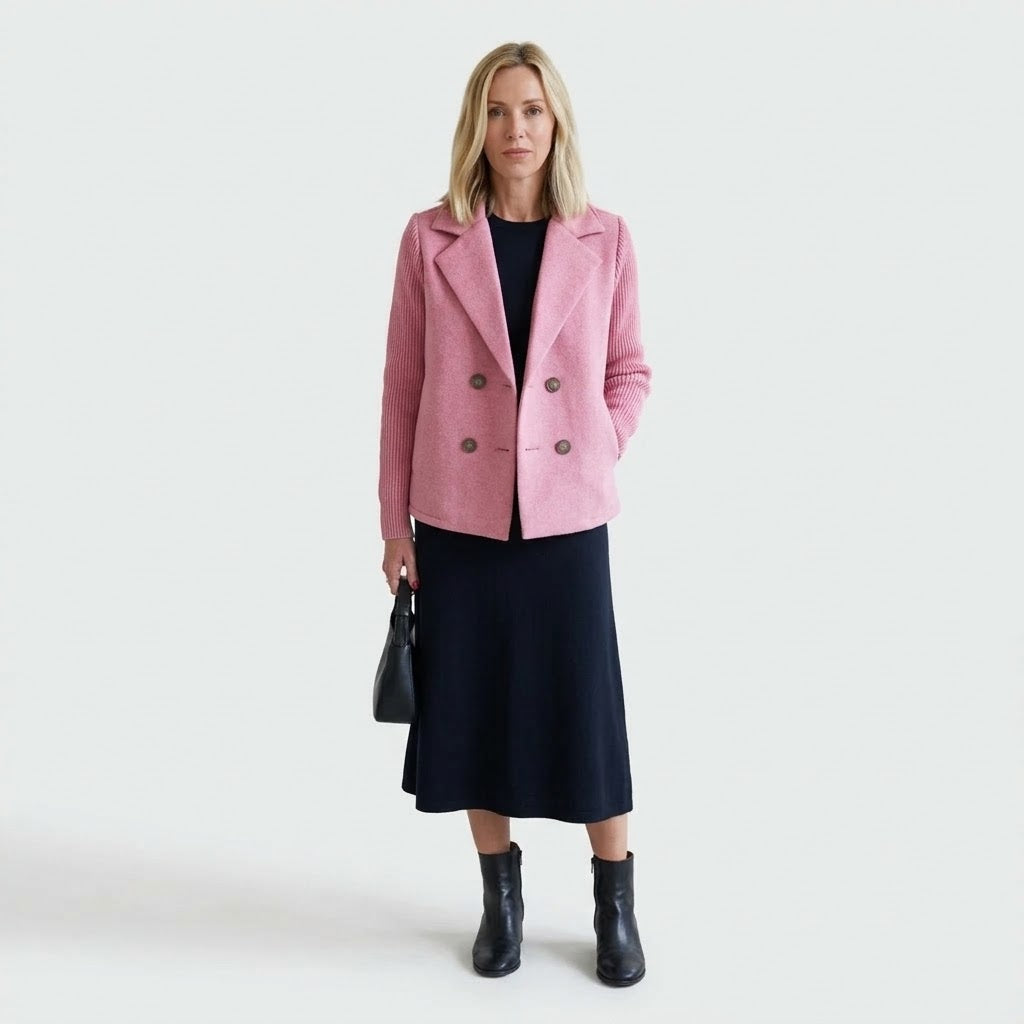 Woman wearing Snuvelle double-breasted lapel coat with knit sleeves