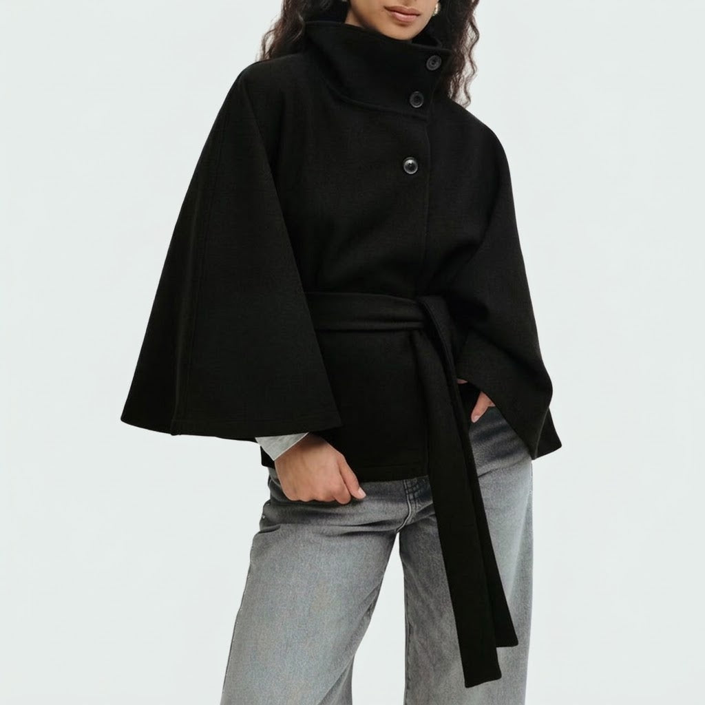Woman wearing Snuvelle high neck batwing belted coat in a solid color