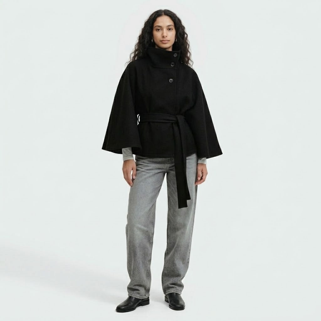 Woman wearing Snuvelle high neck batwing belted coat in a solid color