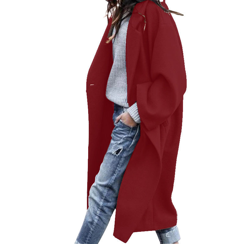 Woman wearing Snuvelle long single-breasted lapel coat with pockets