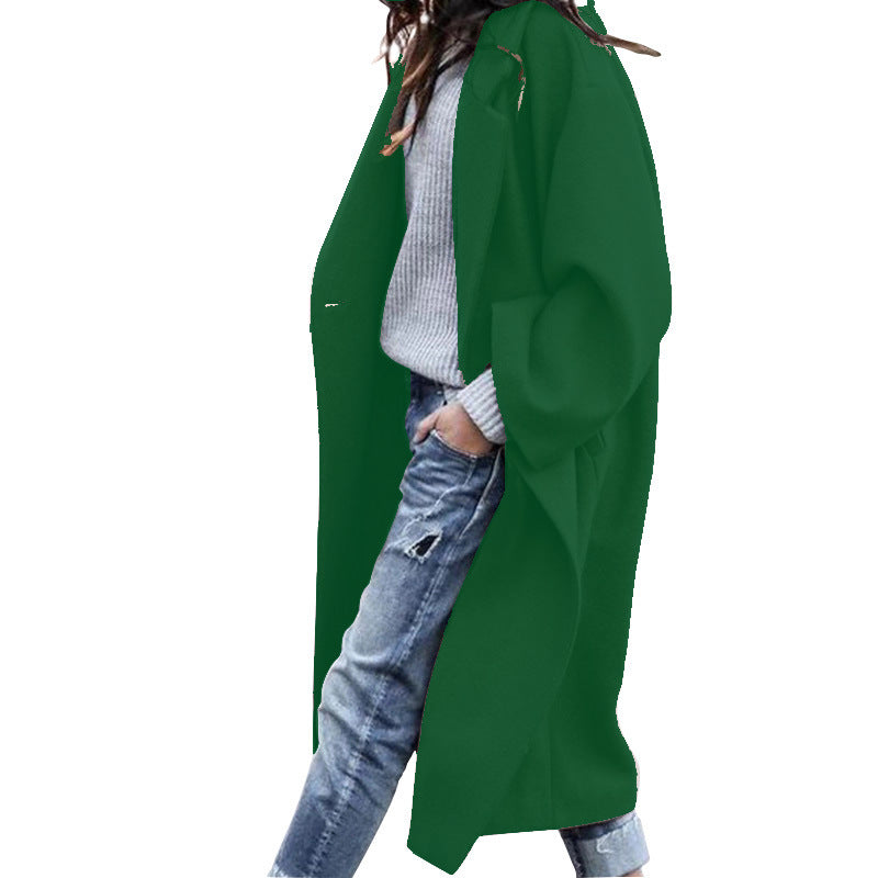 Woman wearing Snuvelle long single-breasted lapel coat with pockets