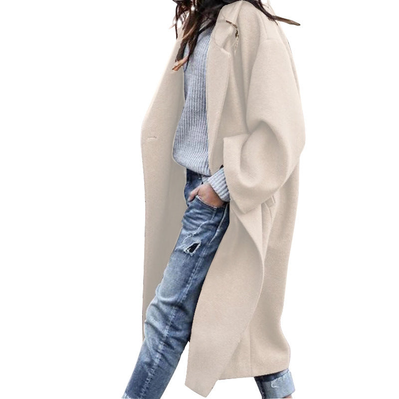 Woman wearing Snuvelle long single-breasted lapel coat with pockets